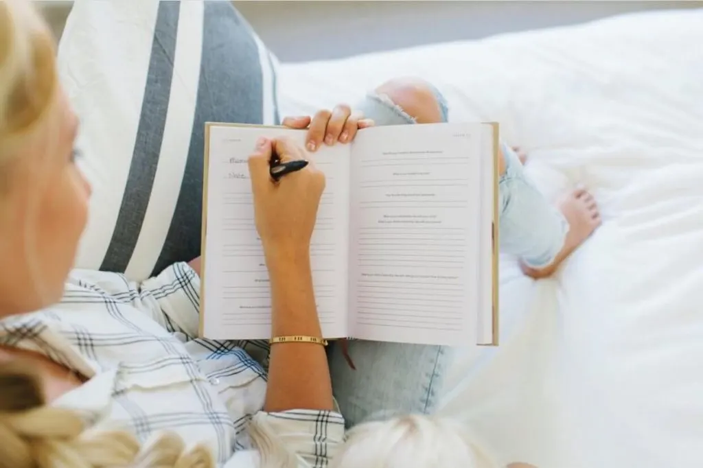 woman writing in journal